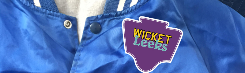 flux-site-feature Close up of blue Varsity Jacket with a purple patch that reads "Wicket Leeks"