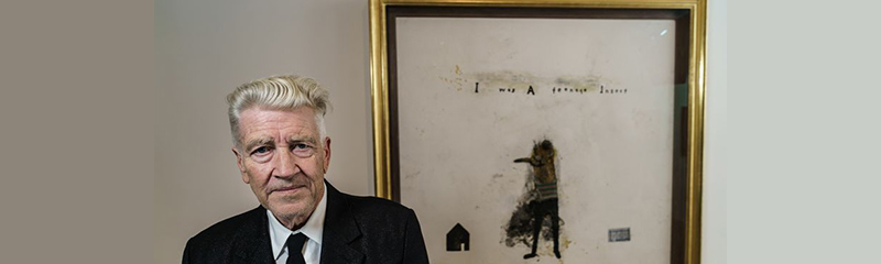 banner a man named David Lynch standing in front of a painting